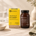 Methylated B-Complex vitamins in a glass jar and yellow packaging sitting on a neutral table in a kitchen